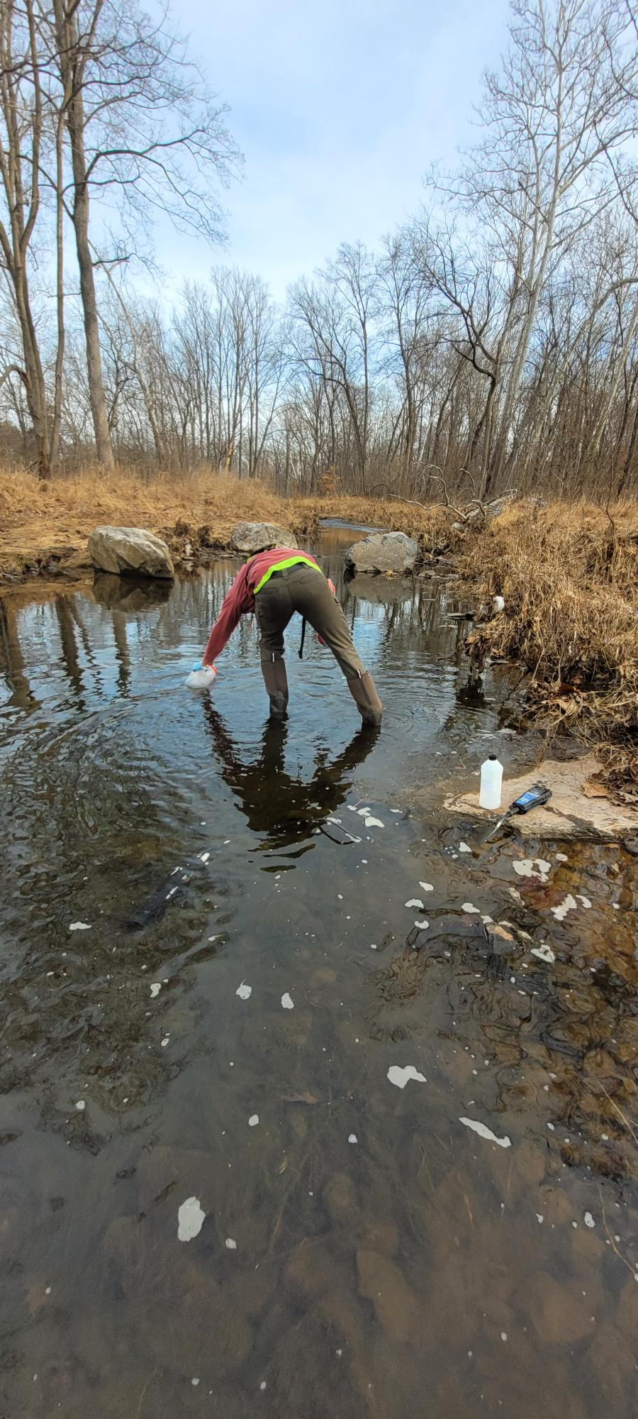 USGS scientist taking water sample from Fairfax County stream.