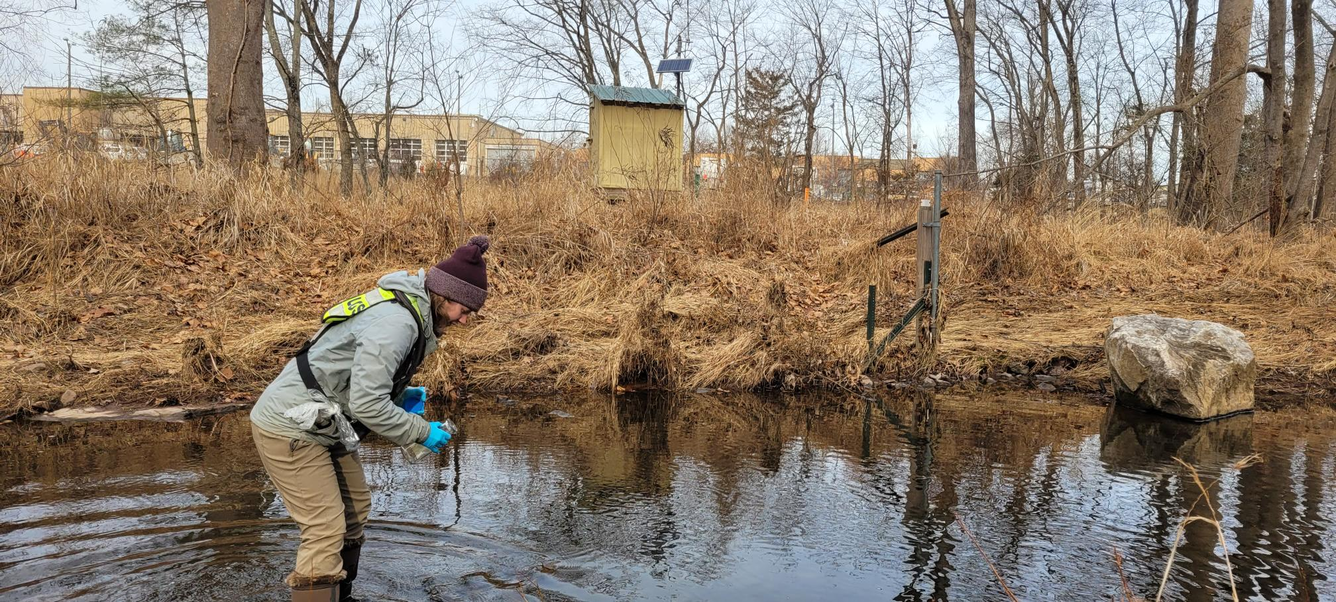 USGS scientist takes water sample from Fairfax County stream.