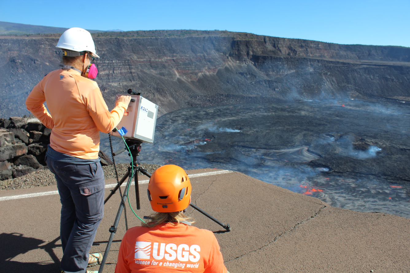 Color photograph of scientists measuring eruption gas