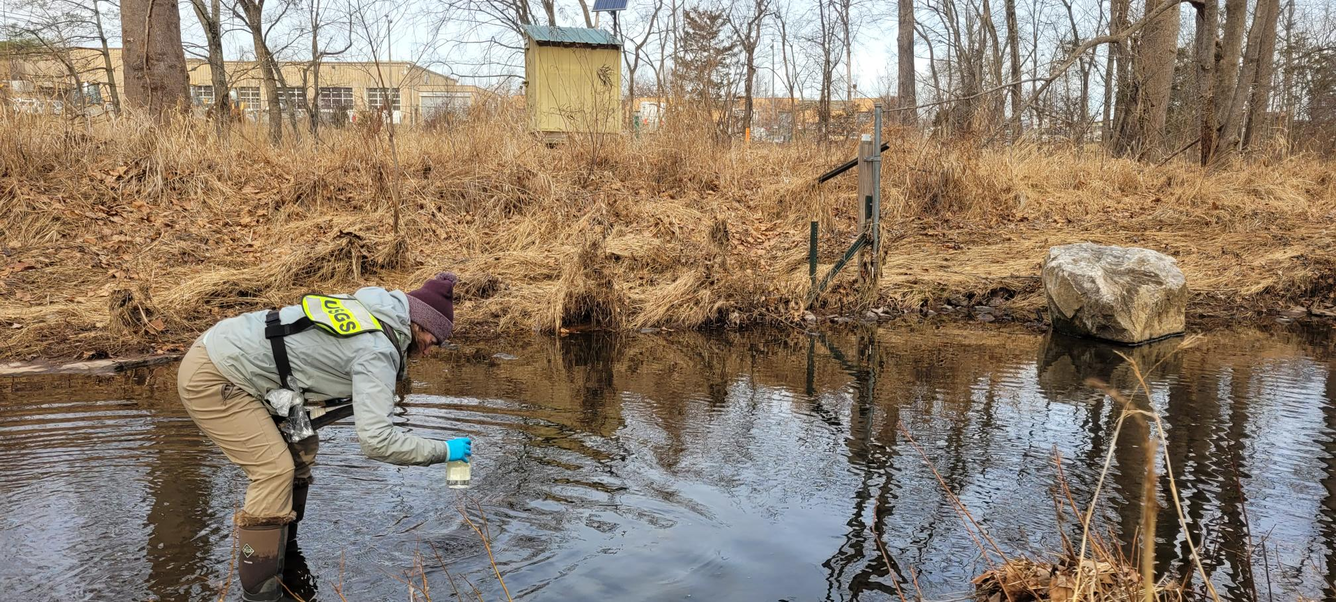 USGS Scientist takes water sample from Fairfax County stream.
