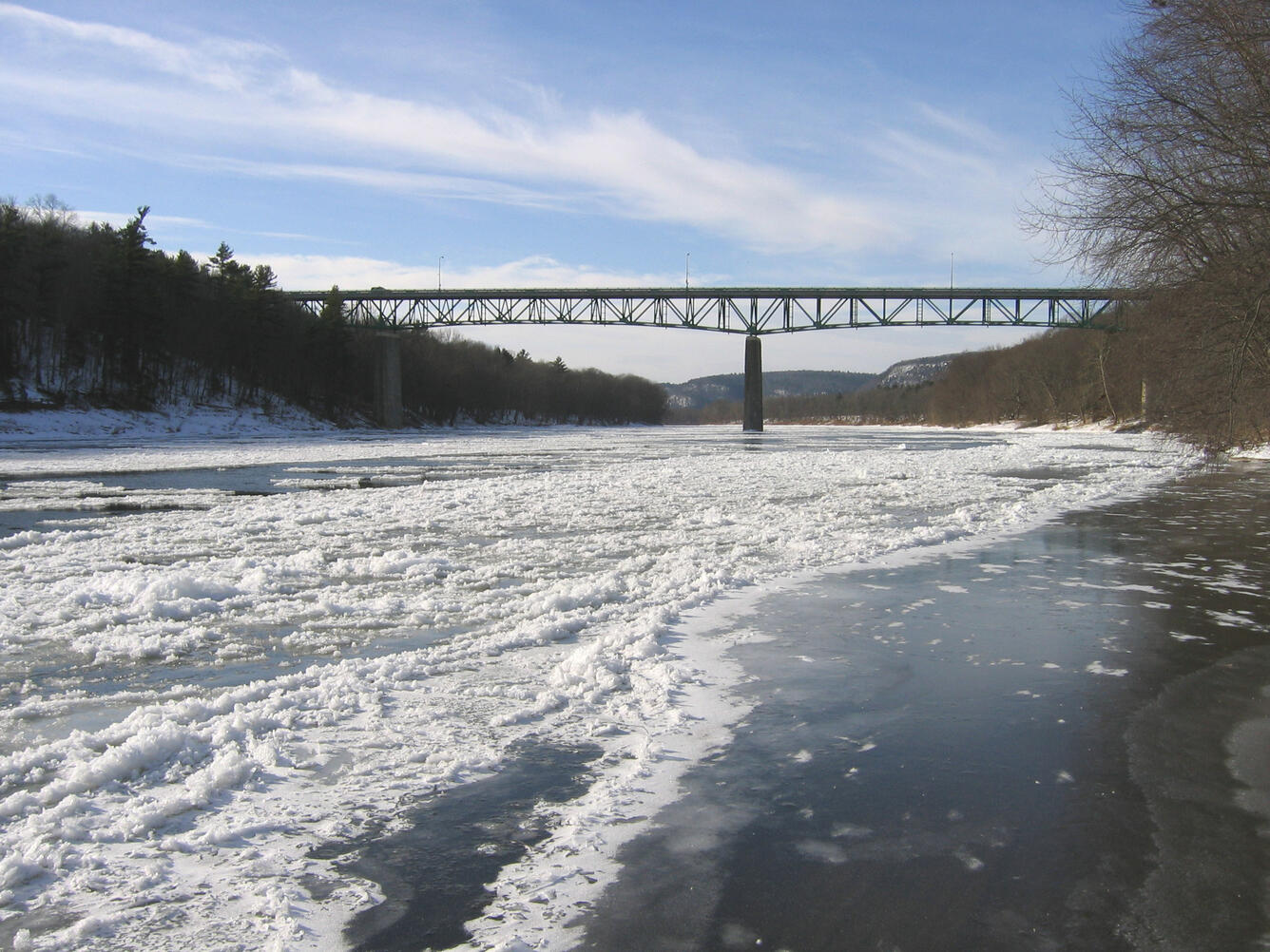 looking along a frozen Delaware River towards the Milford-Montague Bridge