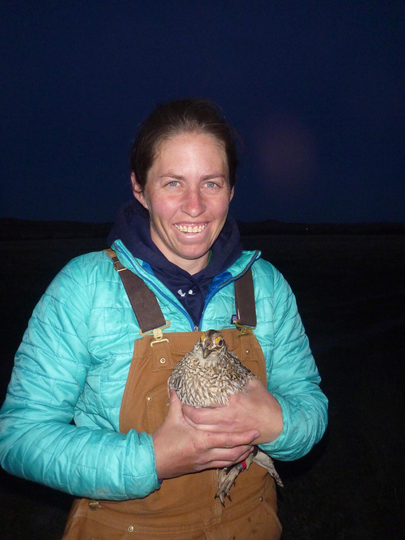 Megan Milligan holding a bird.