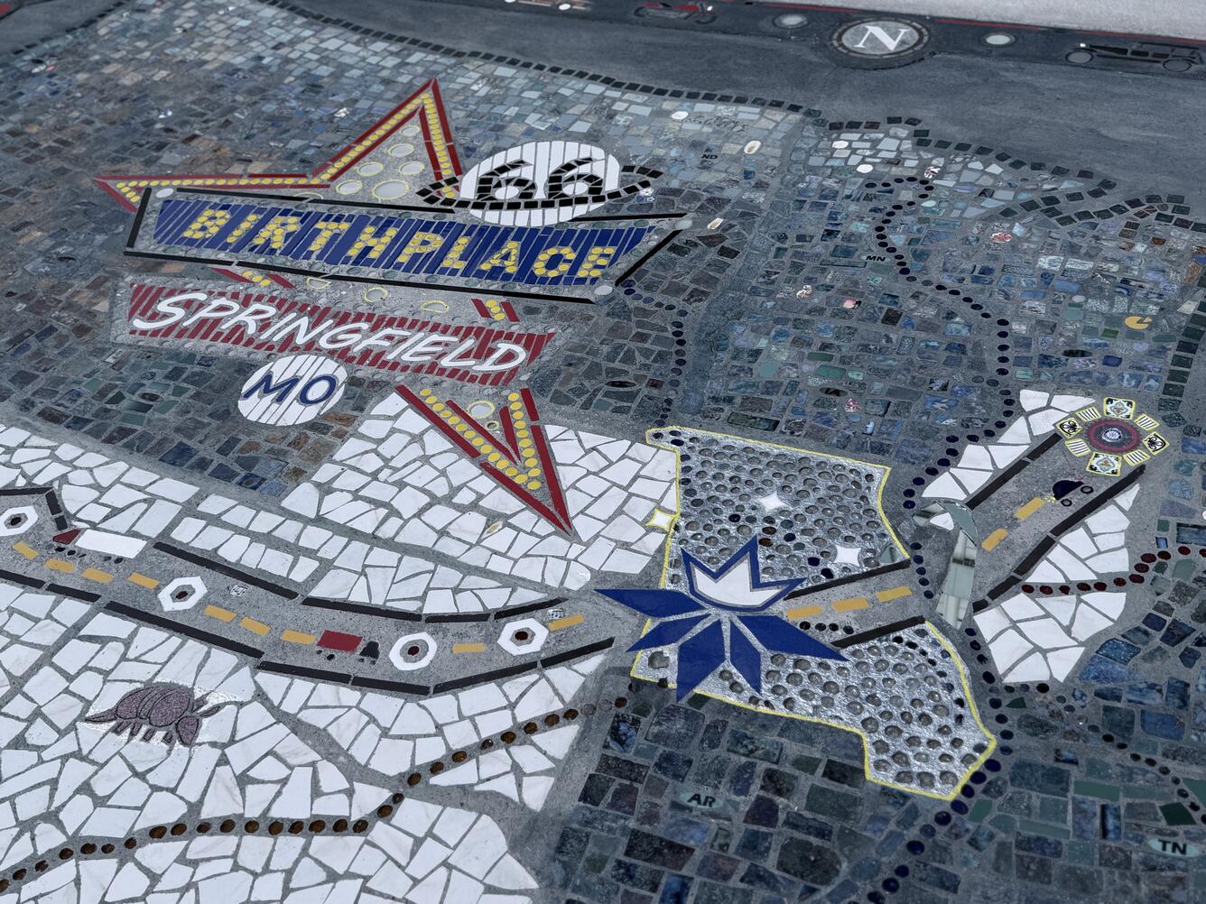 Close-up of the decorative mosaic map’s center featuring a star labeled “Birthplace Springfield MO,”