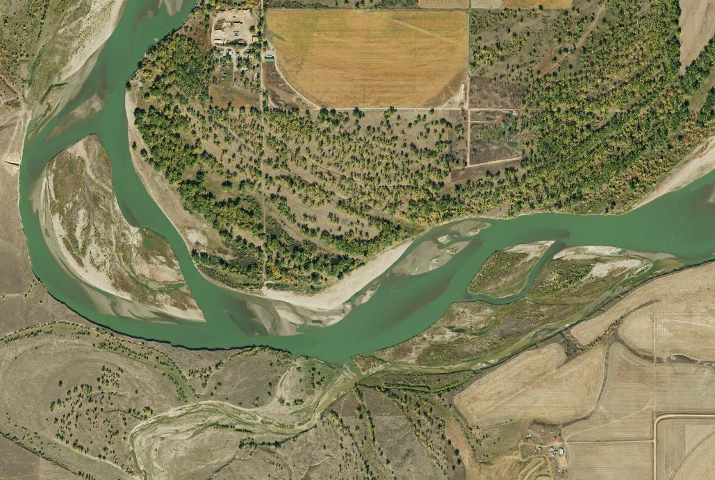 Aerial imagery depicting a river with braided channels and surrounding areas