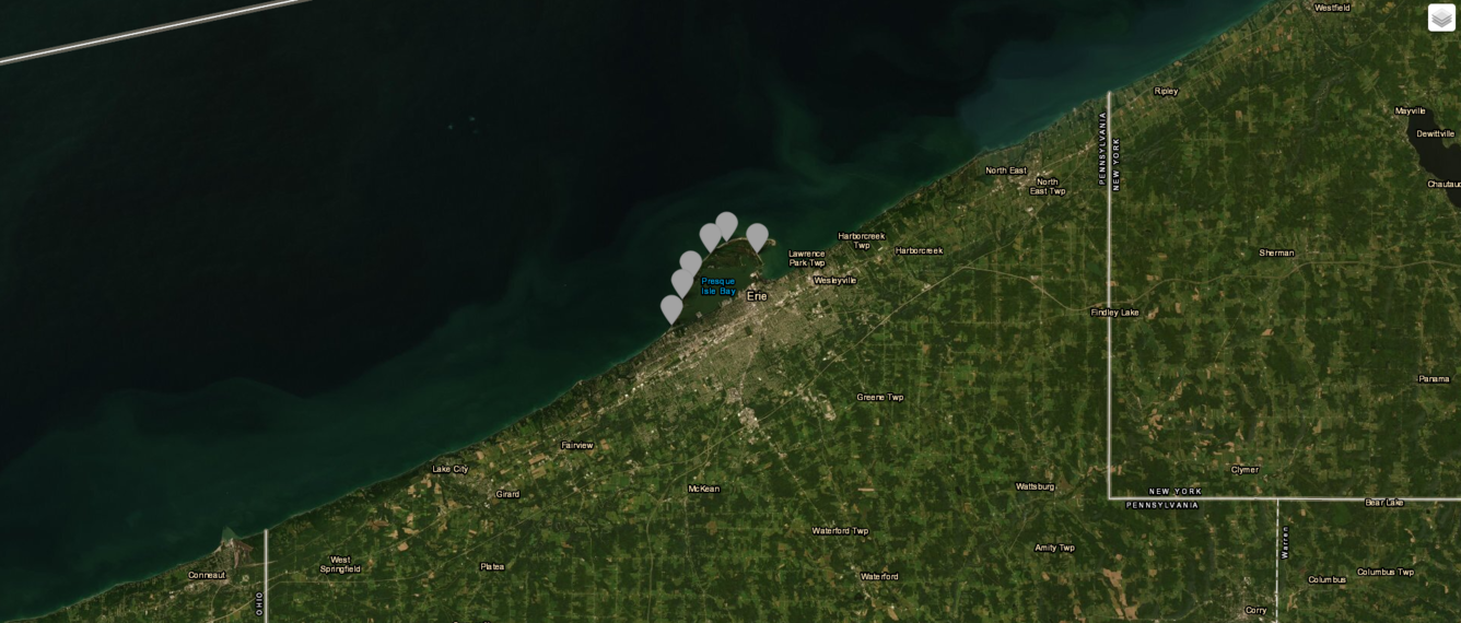 satellite view of Lake Erie and Pennsylvania Shore with green colors in water and dots for beaches