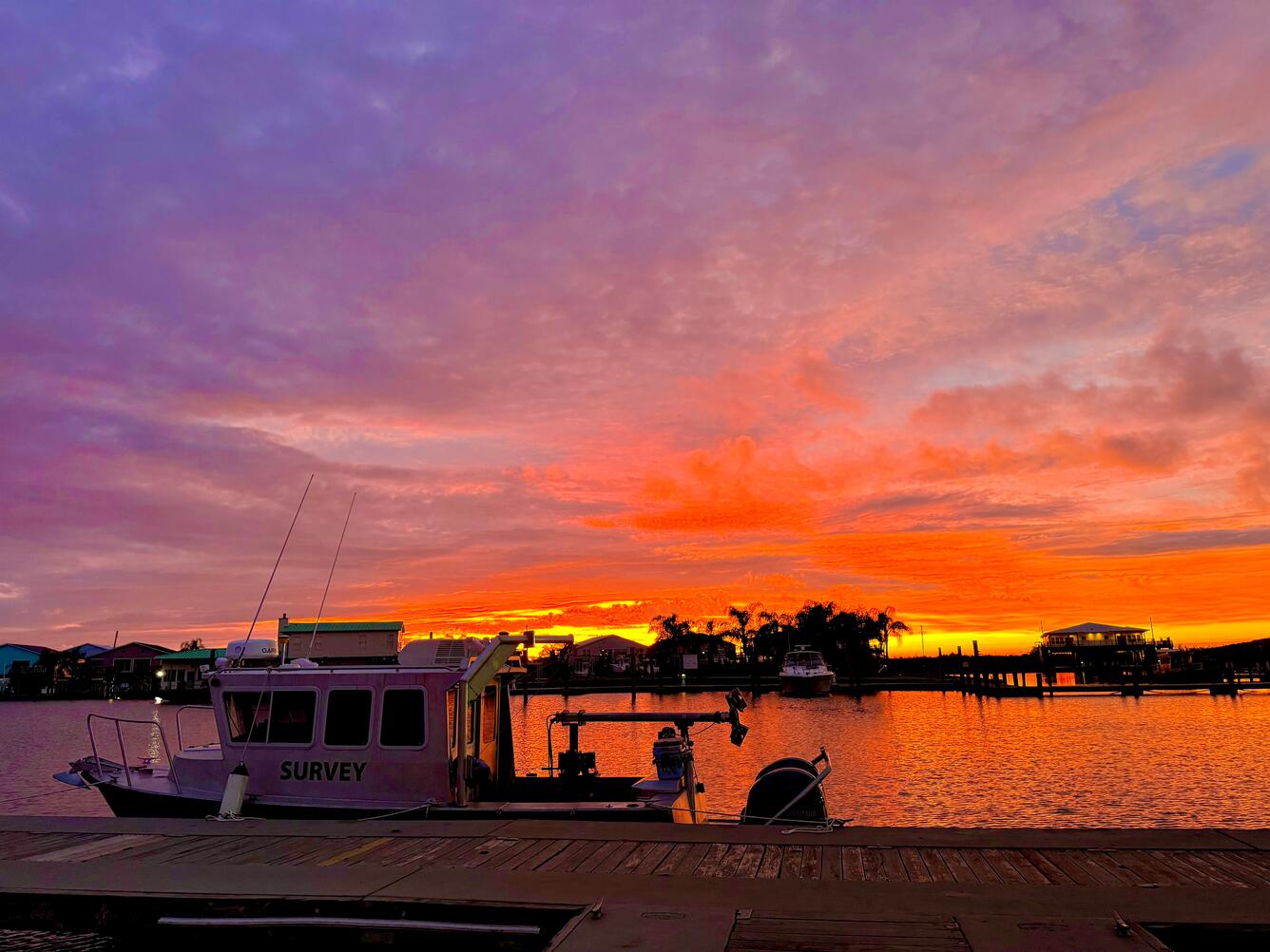 boat docked with sunset in background