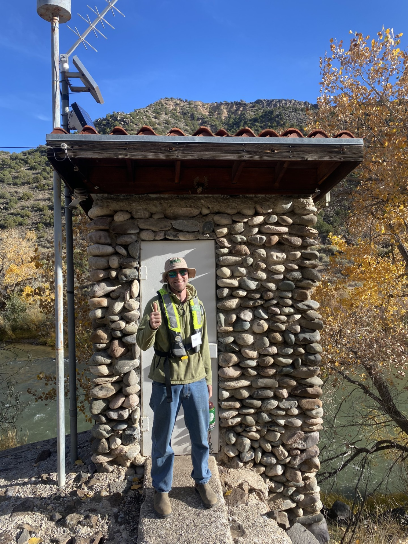 Image of Owen Bertany standing in front of a gage house