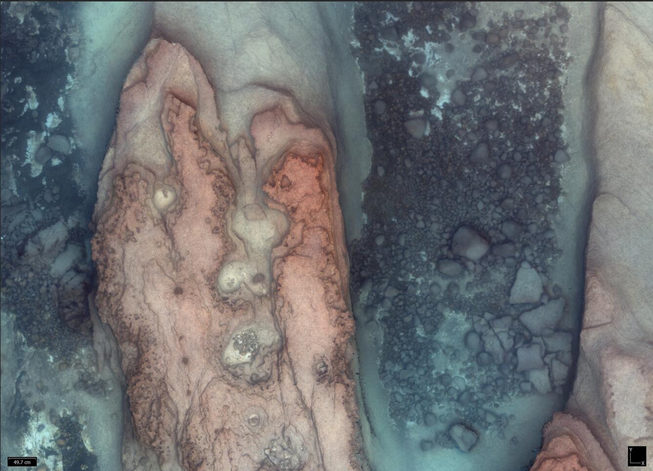 Underwater photograph of the bottom of a lake with rocky area and gravel bed on sand.