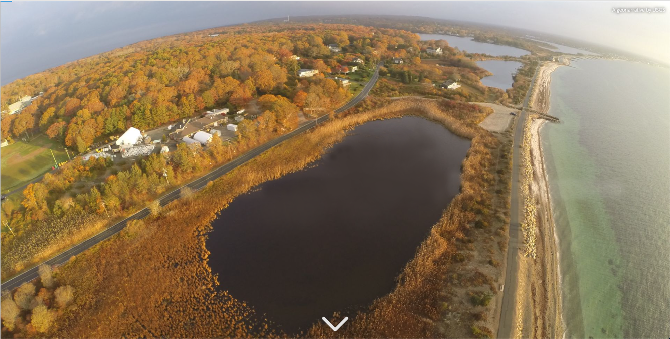 areal view of a coast surrounded by water and coast trees are changing colors during fall 