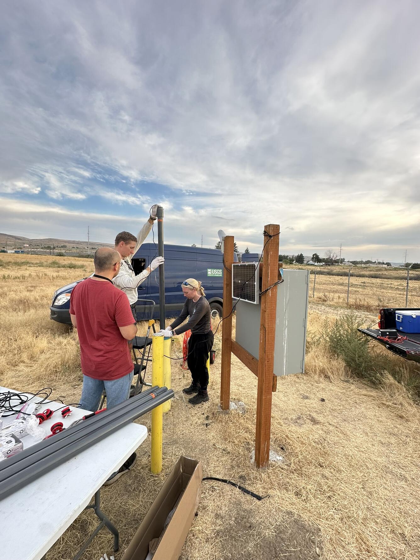 Scientists lower equipment into well
