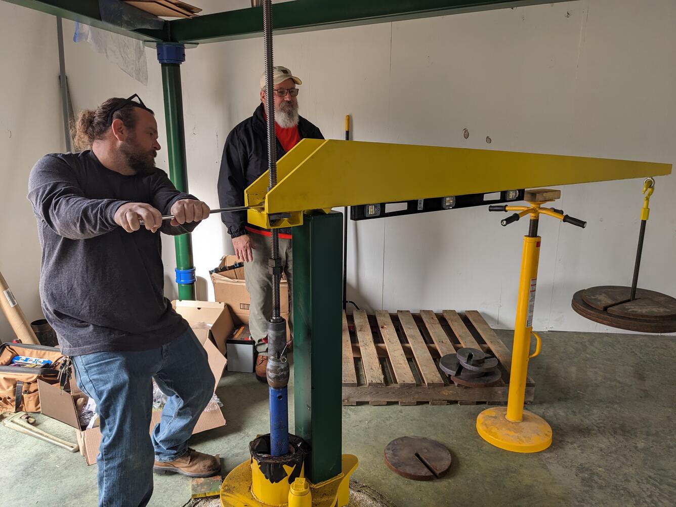 Two USGS scientists balance the fulcrum arm on the West Point extensometer.