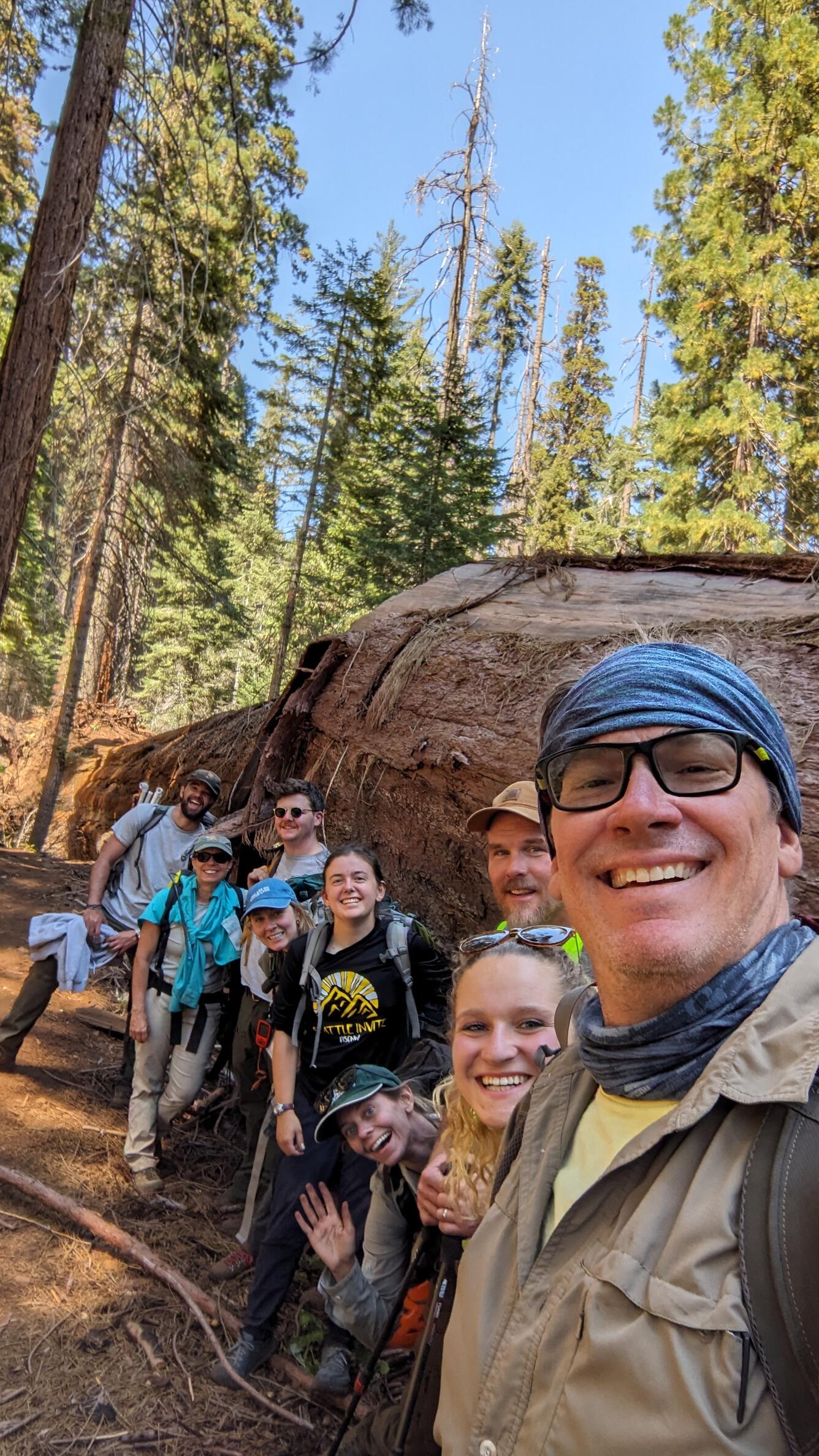 Group of scientists pose for photo in the field