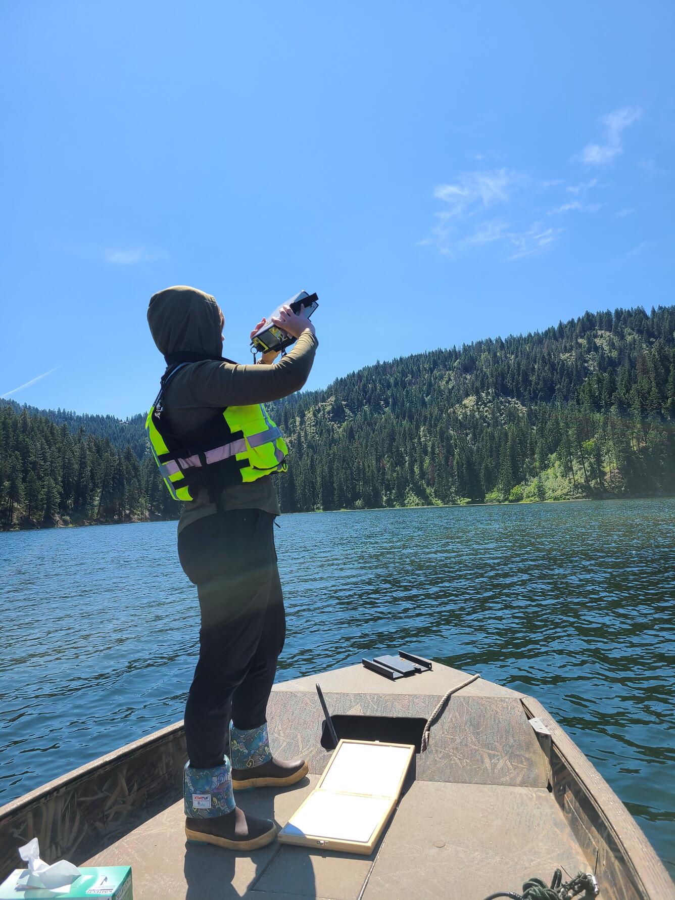 USGS scientist using spectral radiometer to measure light from boat on Fernan Lake, Idaho