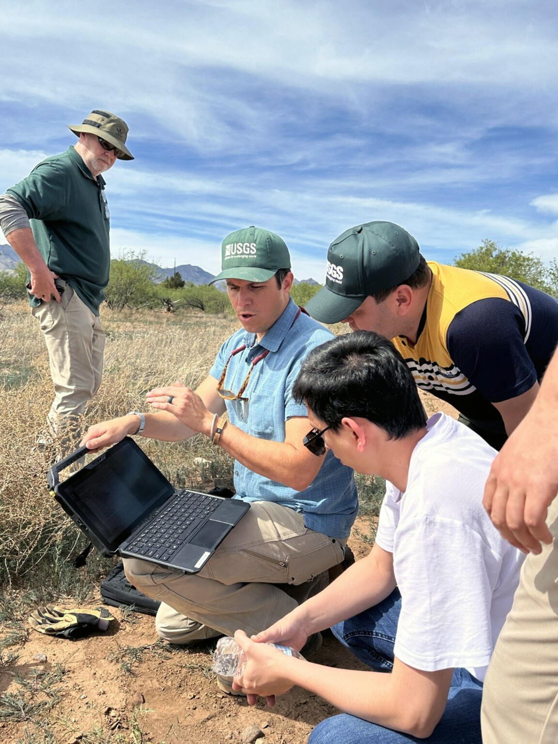 USGS staff demonstrate to Uzbek researchers the process of collecting and recording USGS groundwater data.