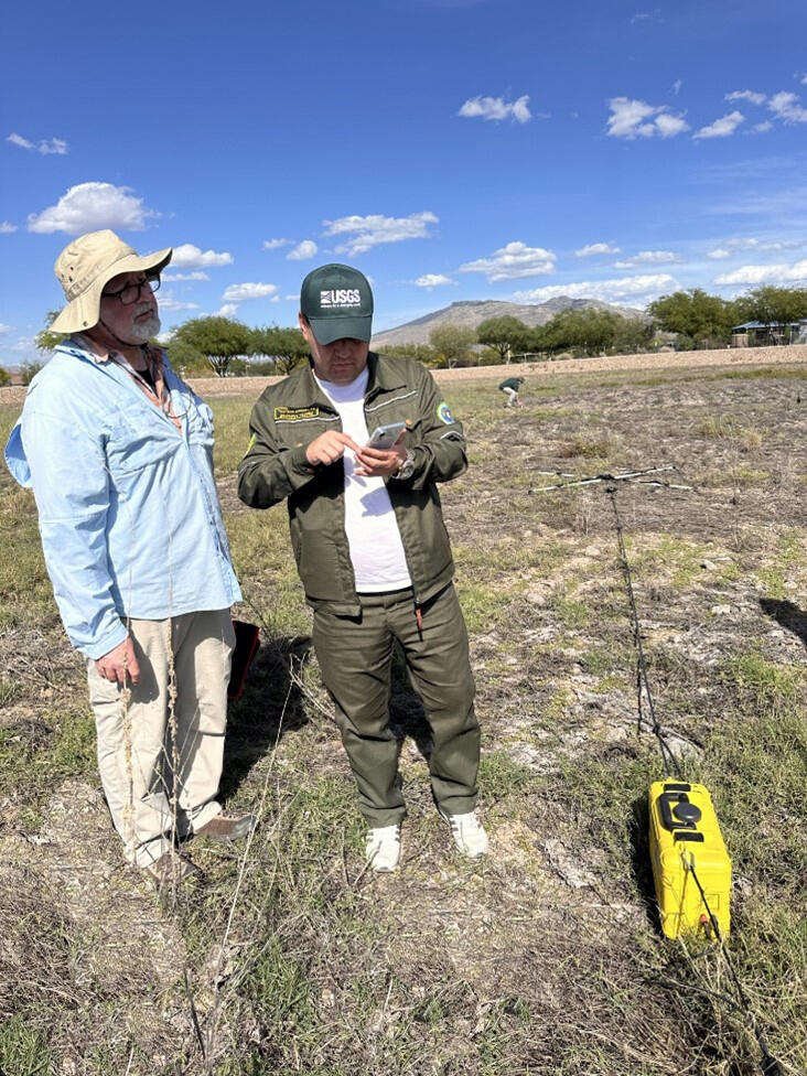 The USGS hydrologist demonstrates a new subsurface geophysics tool in the field