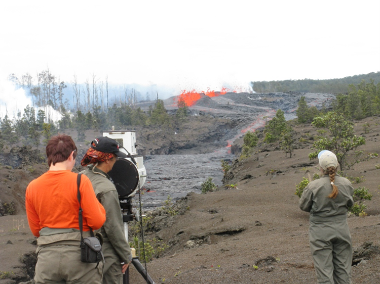 Color photograph of scientists monitoring eruption