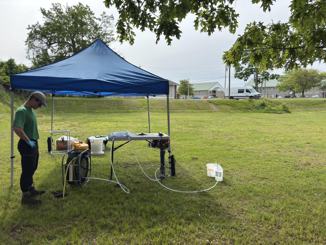 A man checks out a groundwater well that is being pumped.