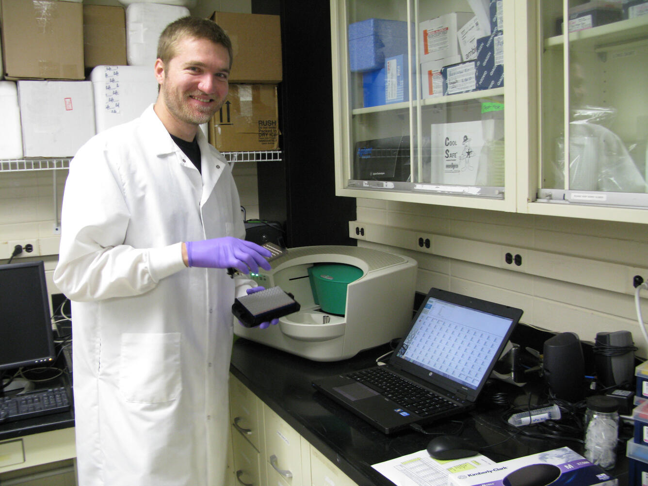 A laboratory technician hold a device used to analyze eDNA
