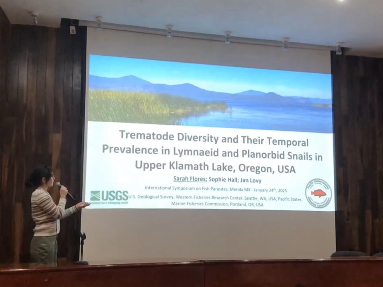 Presentation on parasites in the Upper Klamath Lake on a screen with scientist presenting 