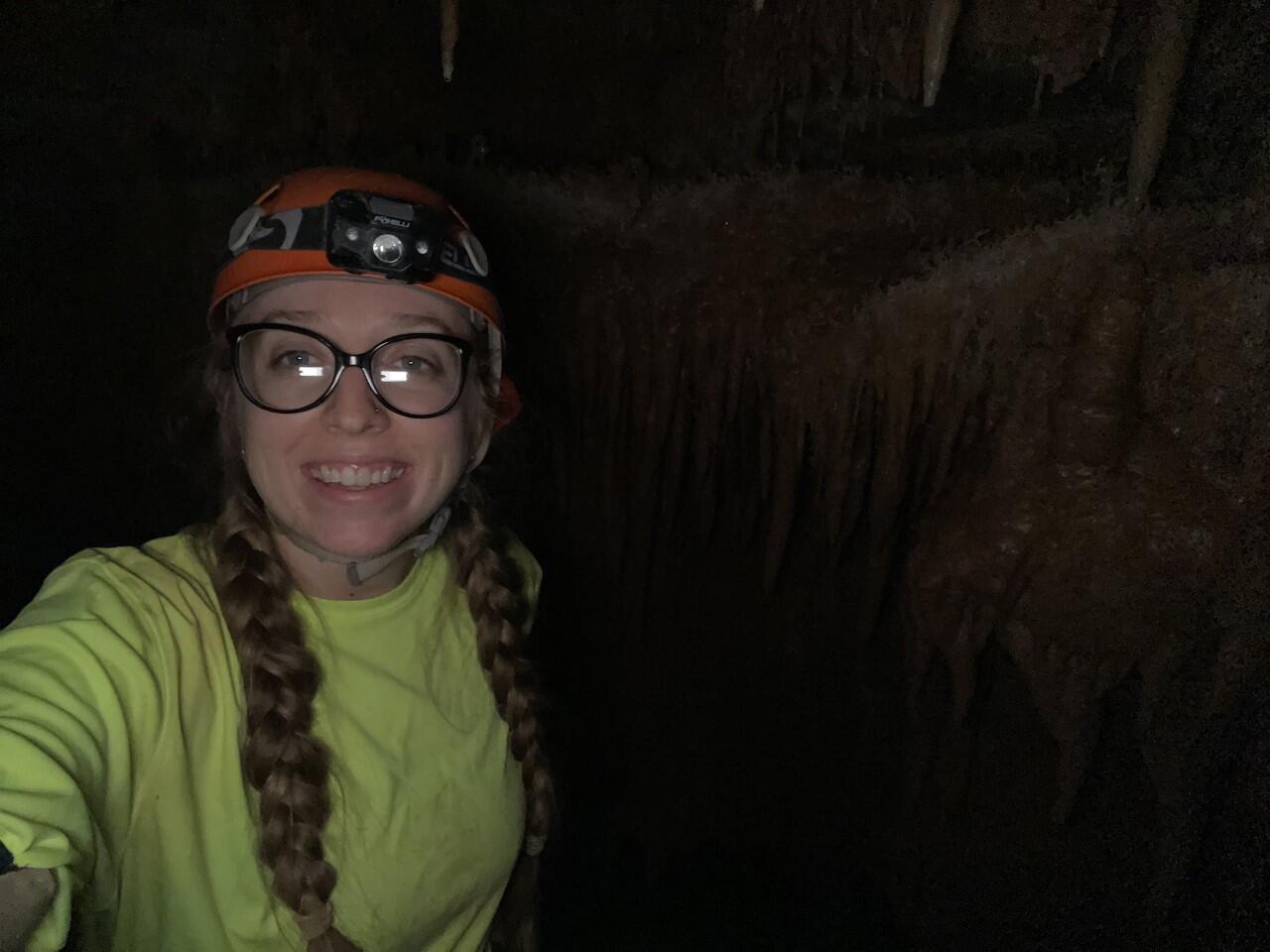 Paige Preston in a dark cave while "caving". 
