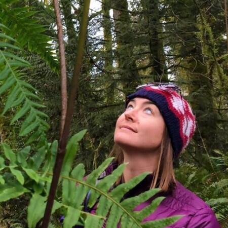 photo of a woman staring at ferns