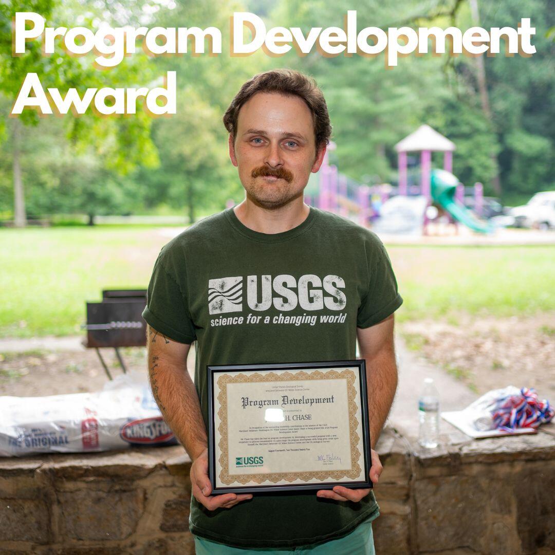 Jason Chase poses with an award plaque.