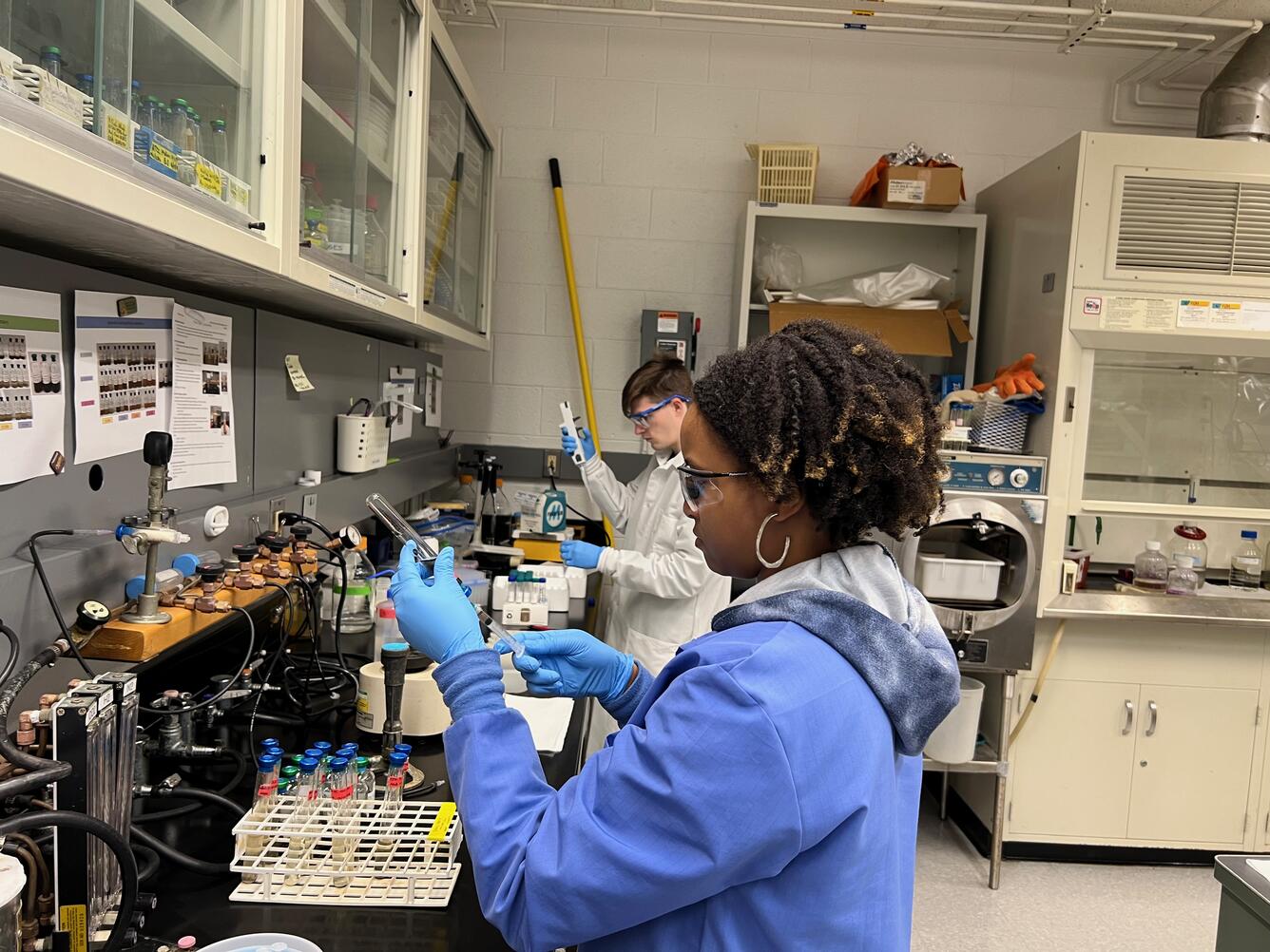 2 employees conduct science in the Reston Microbiology Laboratory