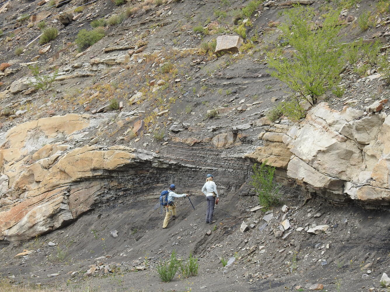 Geologists examining Paleocene fluvial deposits in the Raton Basin, Colorado 