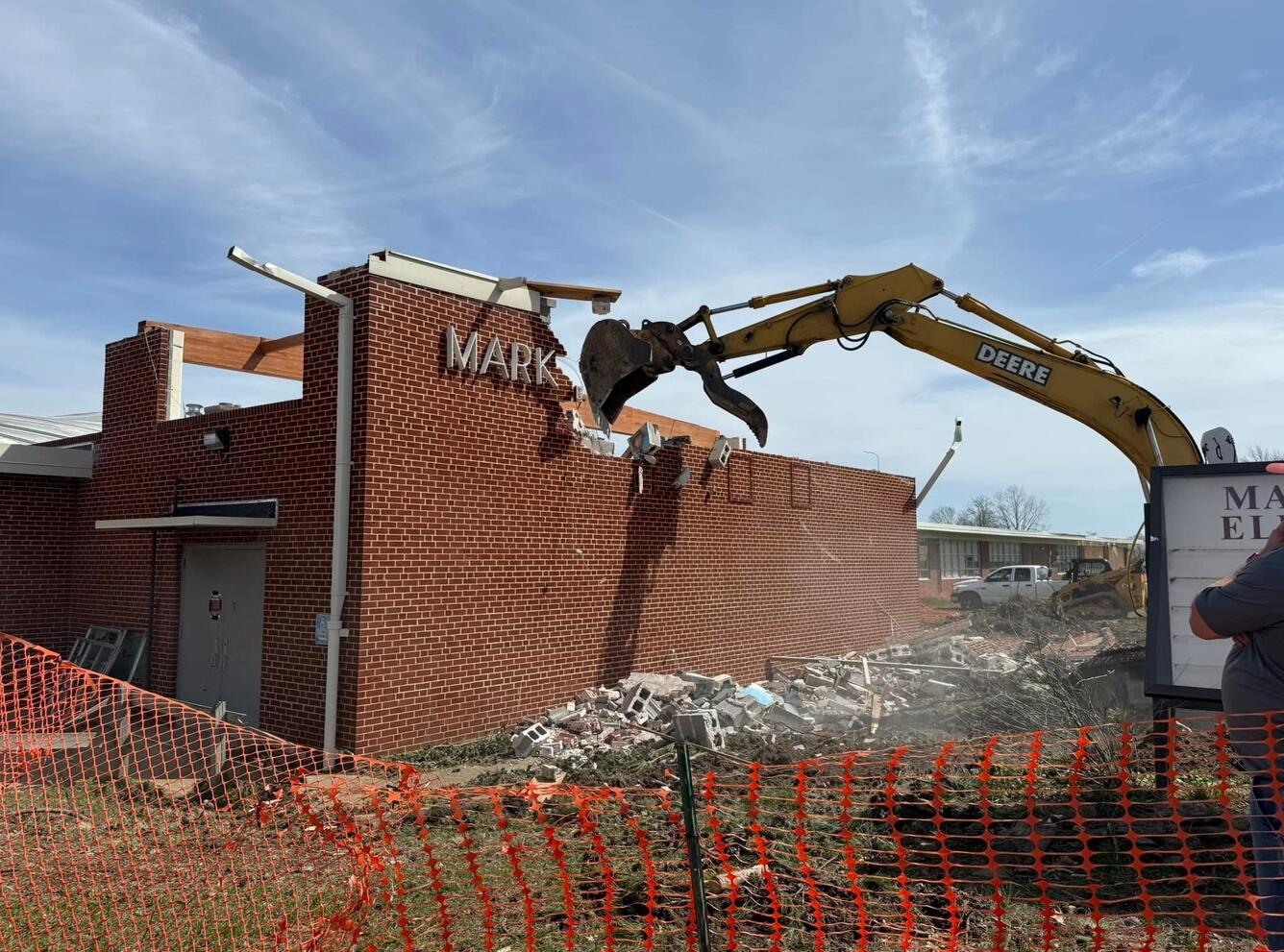 Crane tears down school wall