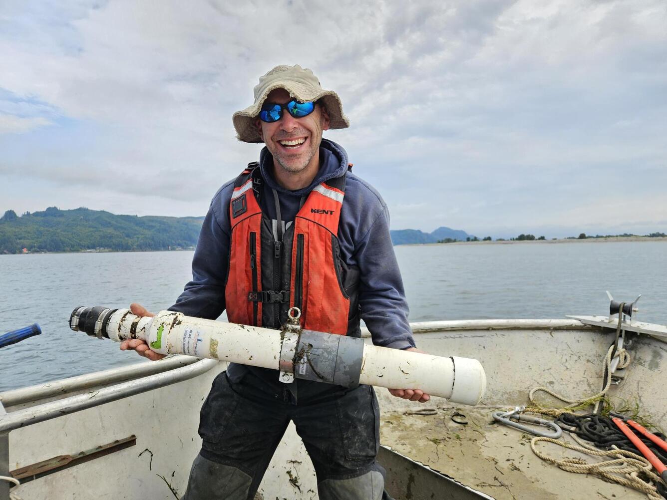Researcher, Ryan Tomka, holding a telemetry receiver for tracking fish