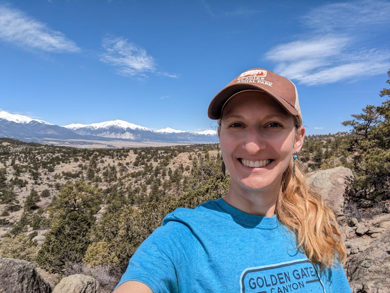 person with trees and mountains in background