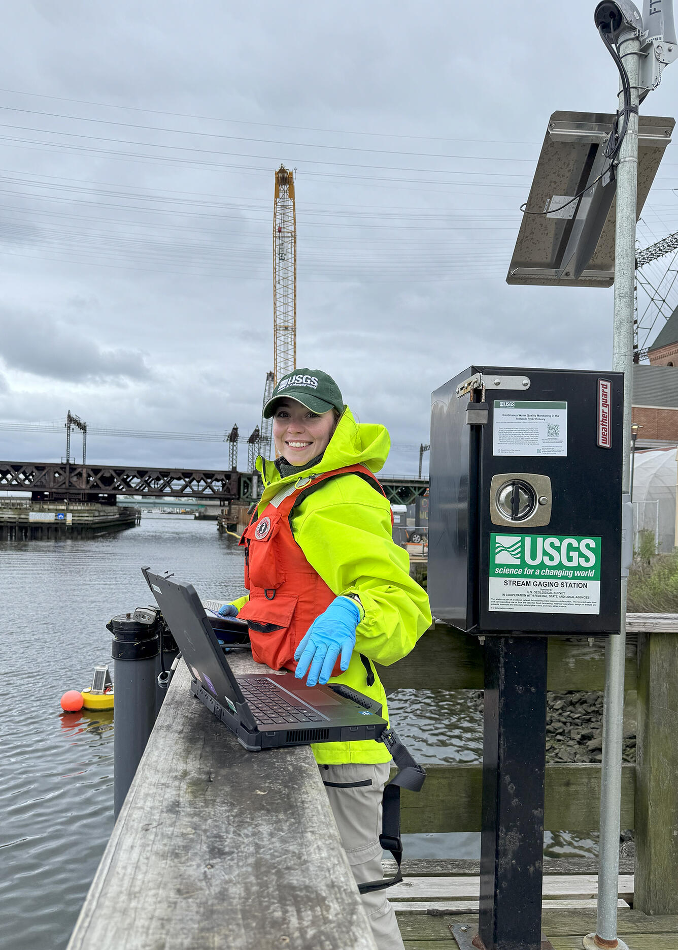 Technician performs a vertical profile and routine maintenance on continuous water quality monitors on the Norwalk River.