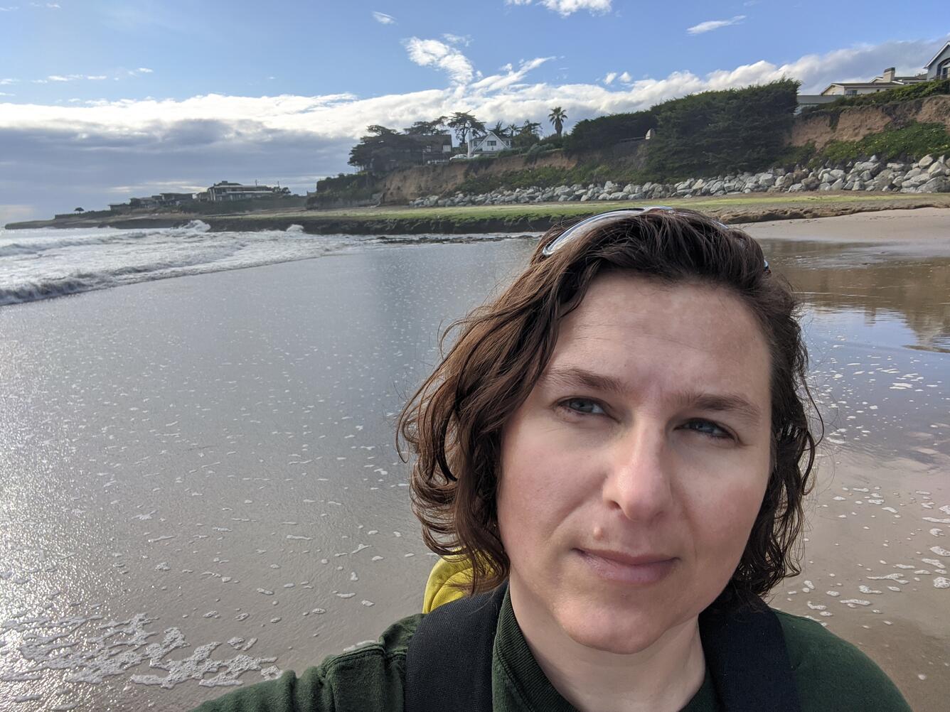 Photo of Andrea O'Neill doing fieldwork on a beach