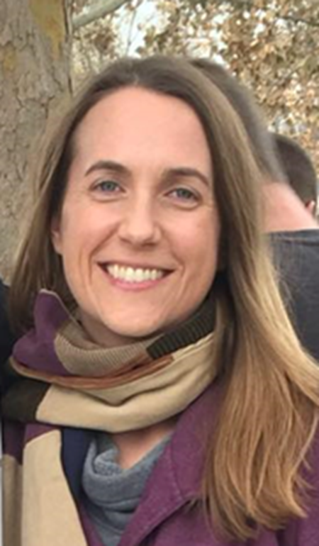 Photograph of Sarah E Peterson wearing a scarf with trees in the background