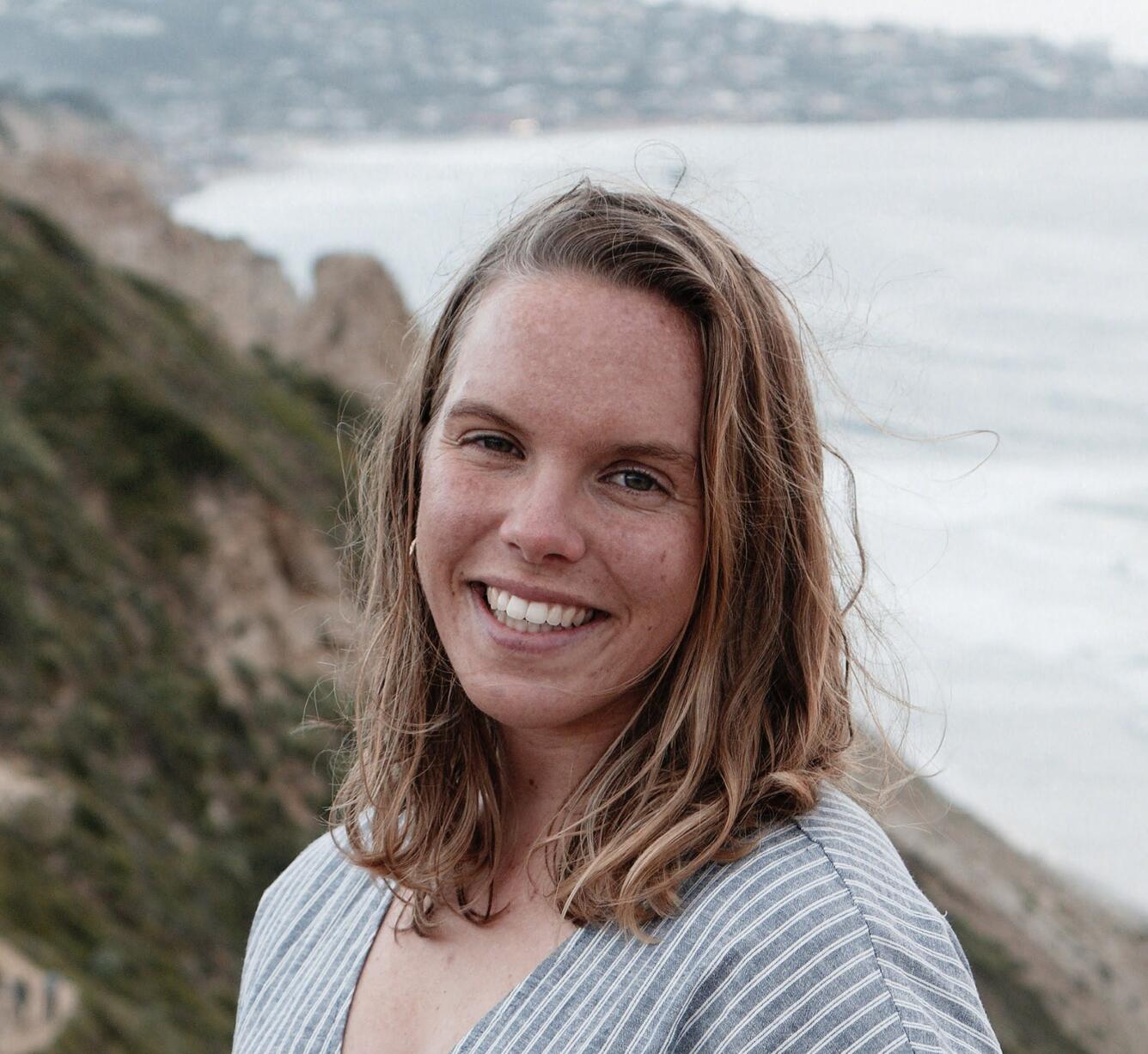 White woman with freckles and golden hair looking at camera