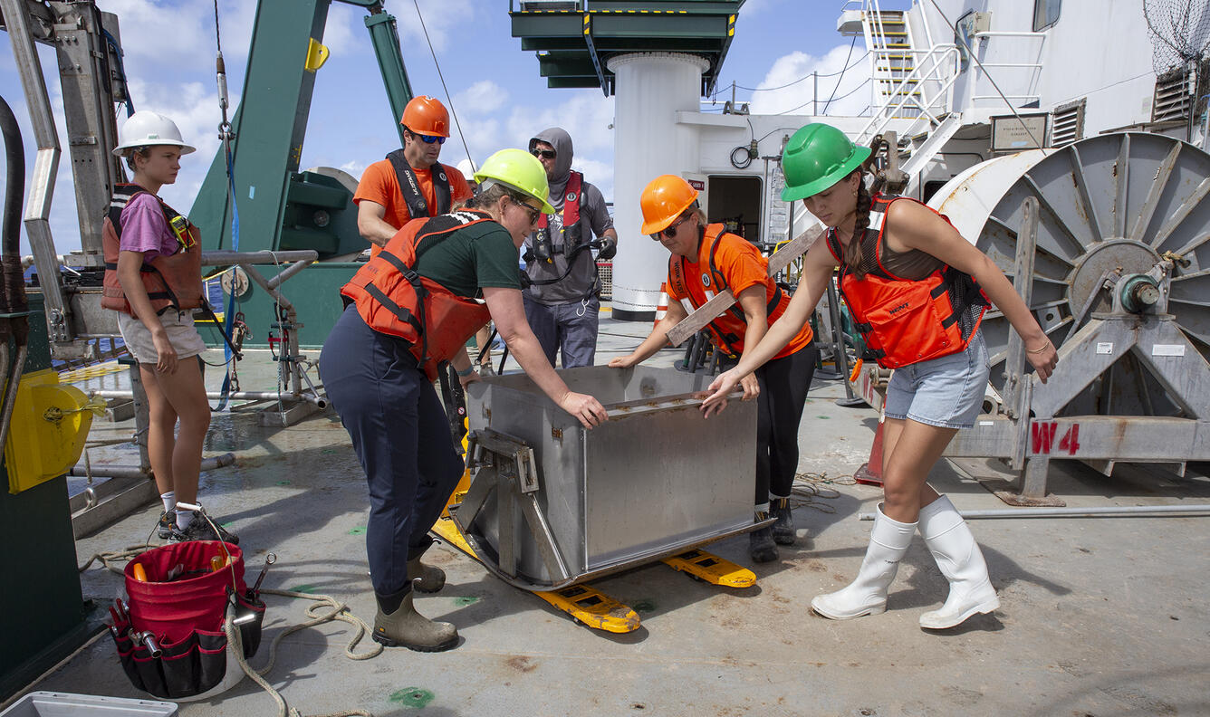 Scientists preparing to process a box core sample during the Hawaii Abyssal Nodules Expedition