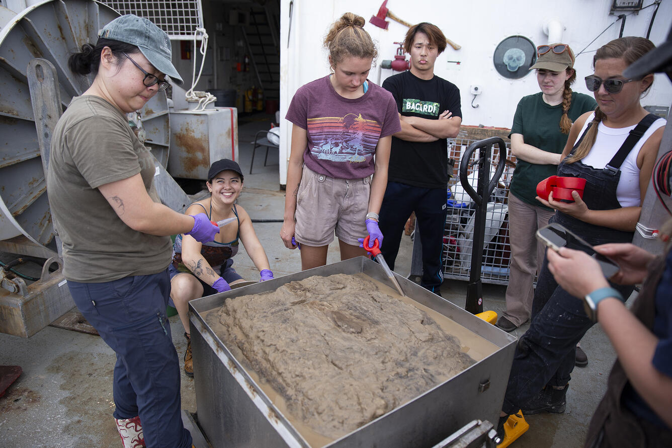 Scientists removing top water from a box core sample during the Hawaii Abyssal Nodules Expedition