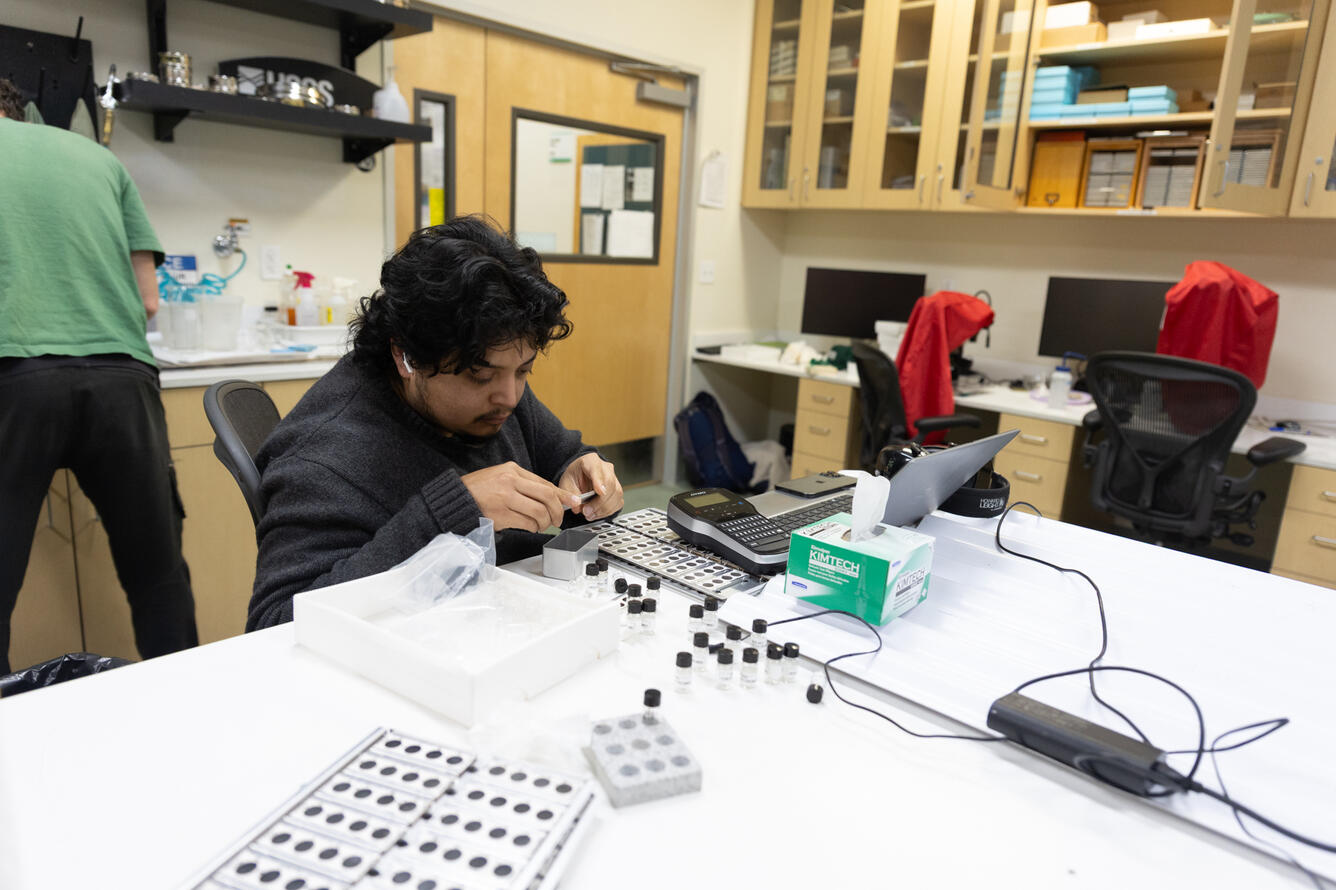 Scientists analyzing material extracted from sediment cores