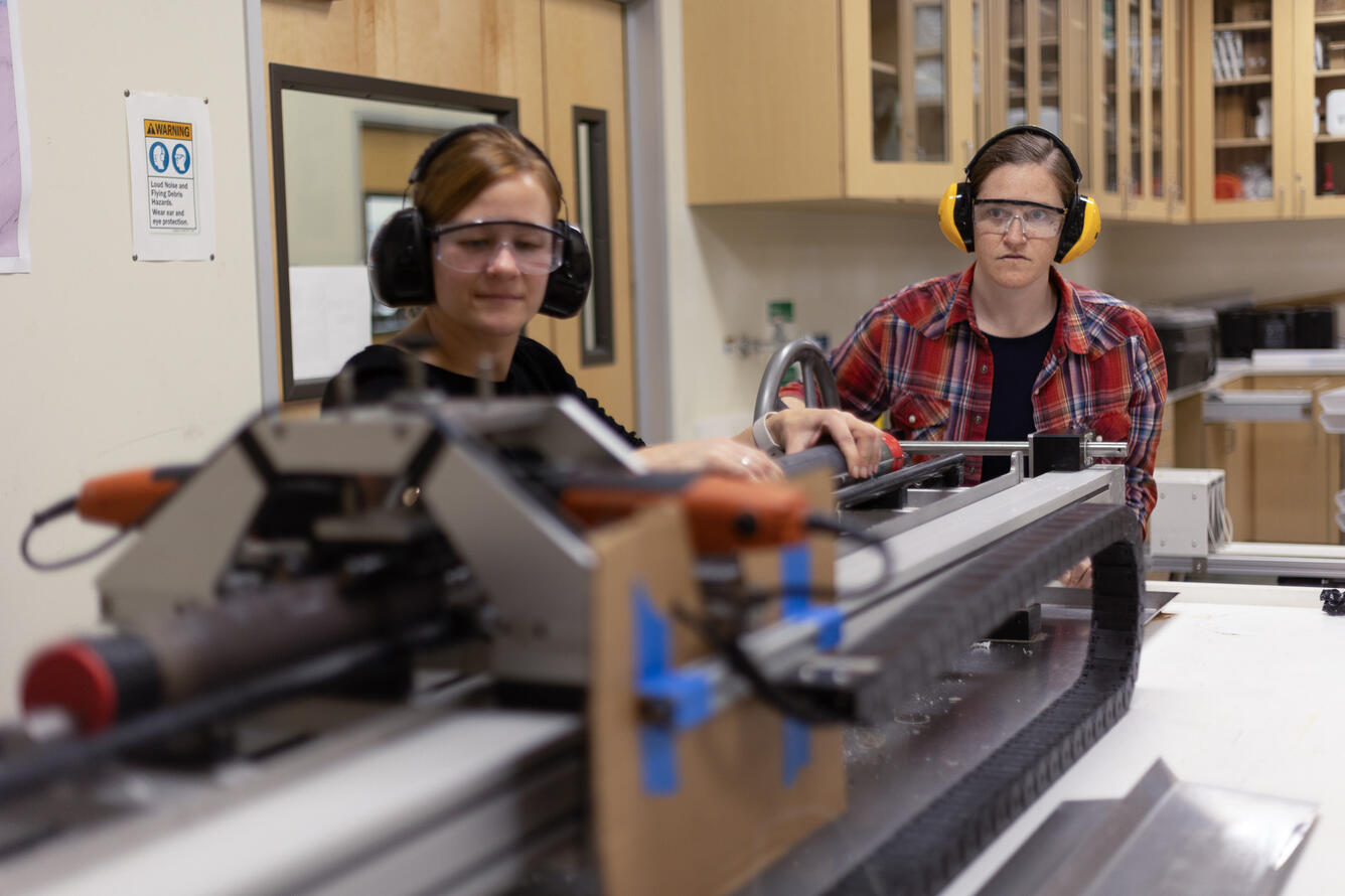 Scientists splitting a sediment core with the GeoTek core splitter