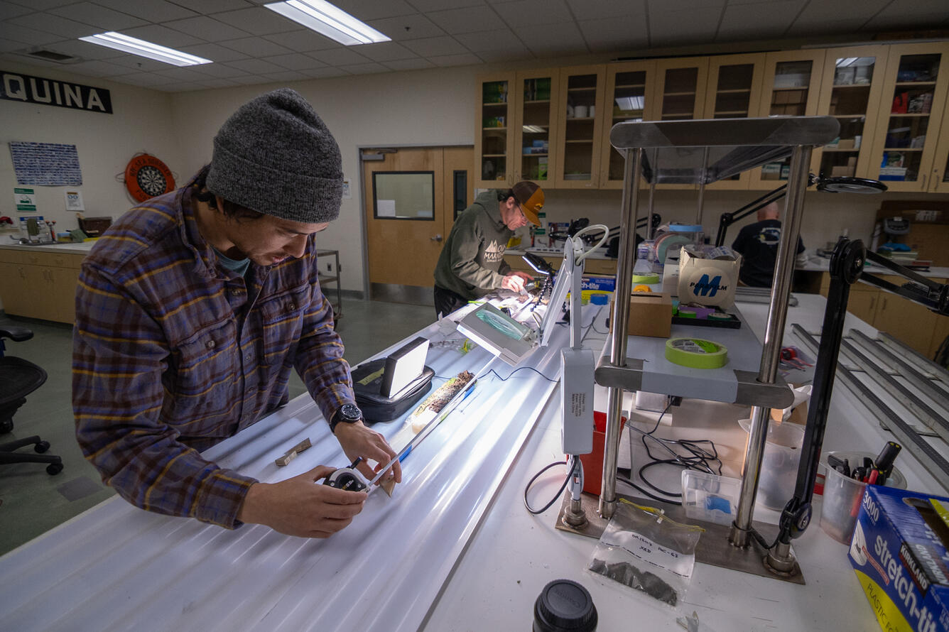 Scientists sub-sampling split sediment cores