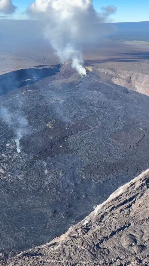 Color photograph of volcanic crater with vents and lava flows