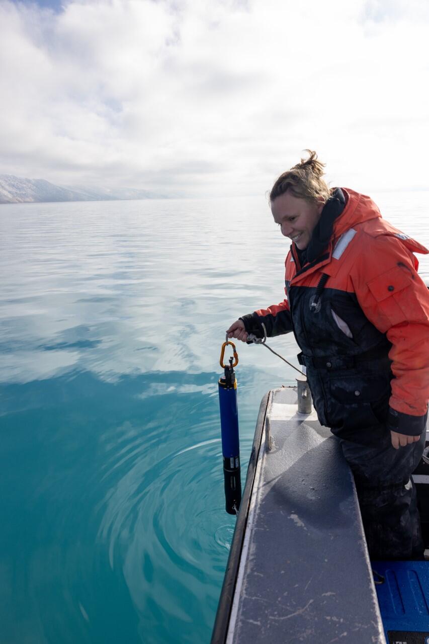 Hydrologist, Serena Seawolf, holds on to Sonde, water-quality instrumentation on Bear Lake.