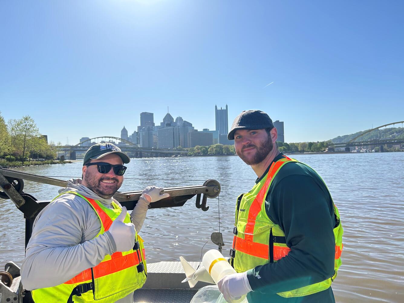 Pittsburgh skyline on river with 2 persons in a boat
