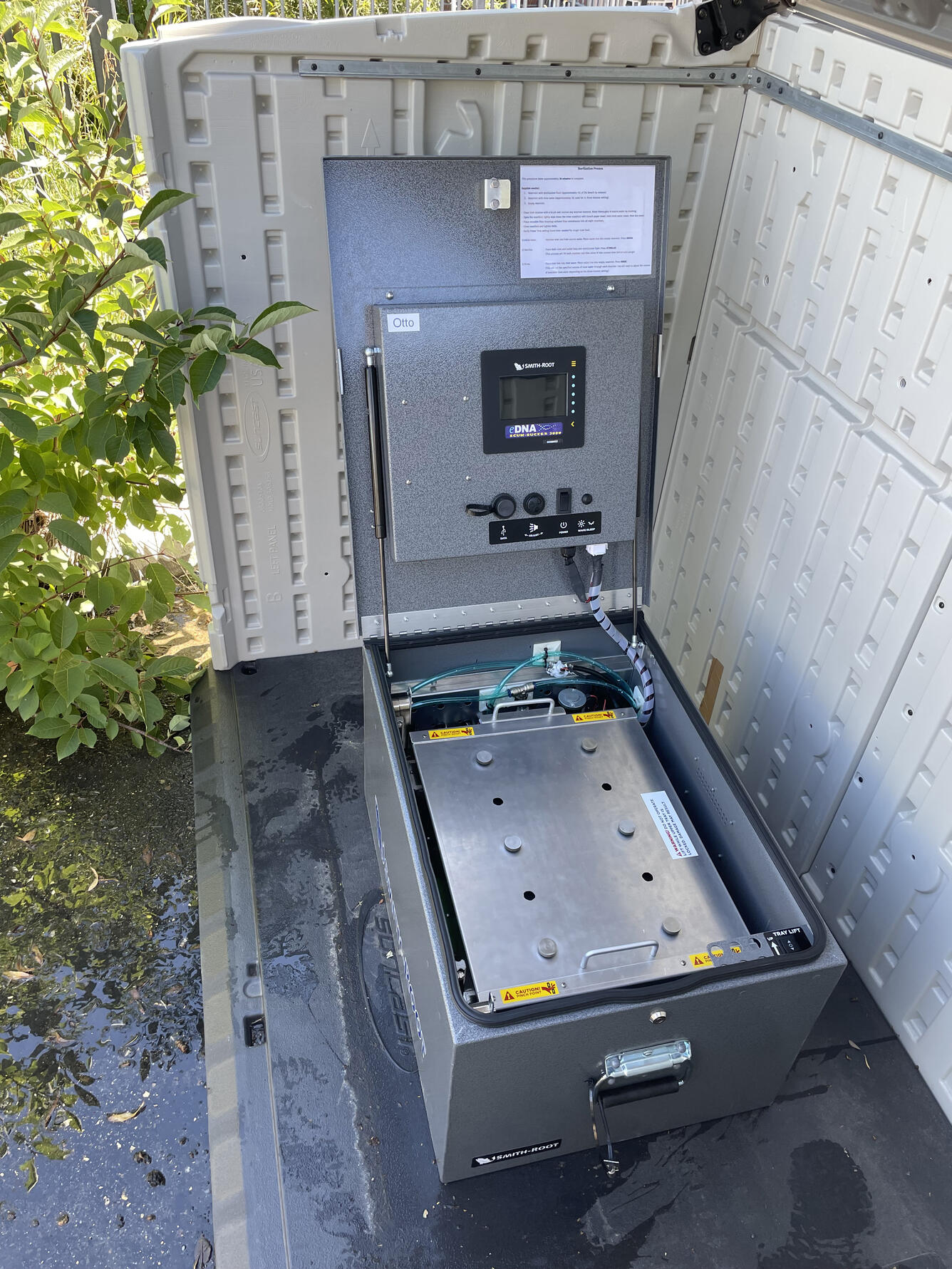 An open metal box holds filters and scientific equipment for water sampling 