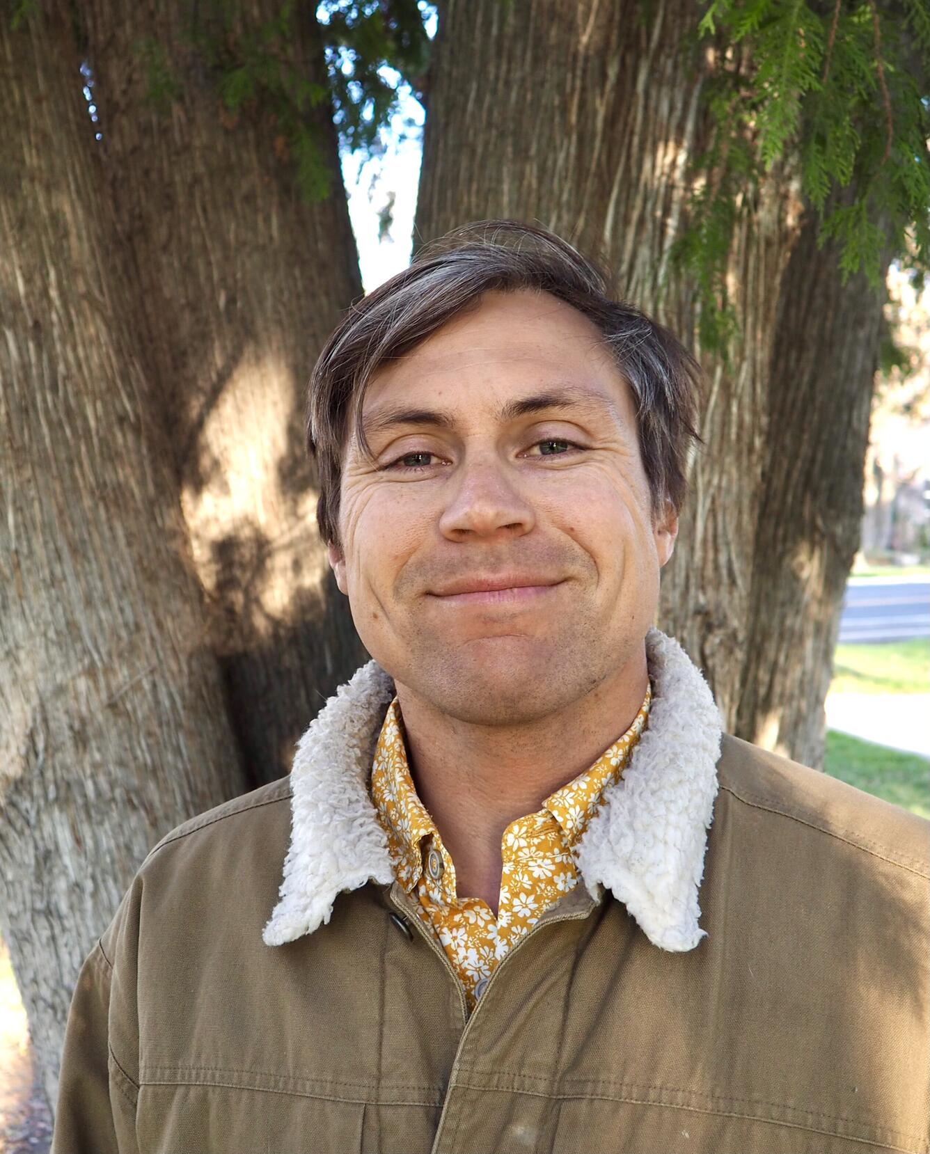 Profile picture for David Soderberg. A man standing in front of a tree with brown hair and a warm jacket..