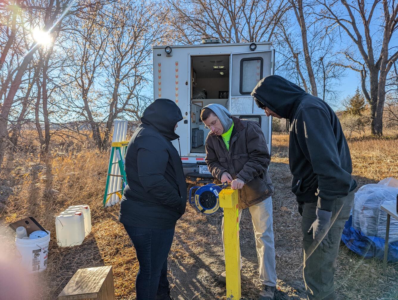 USGS hydrologist Bill Eldridge demonstrates how to measure groundwater levels with members of the Standing Rock Sioux Tribe near Cannon Ball, ND.