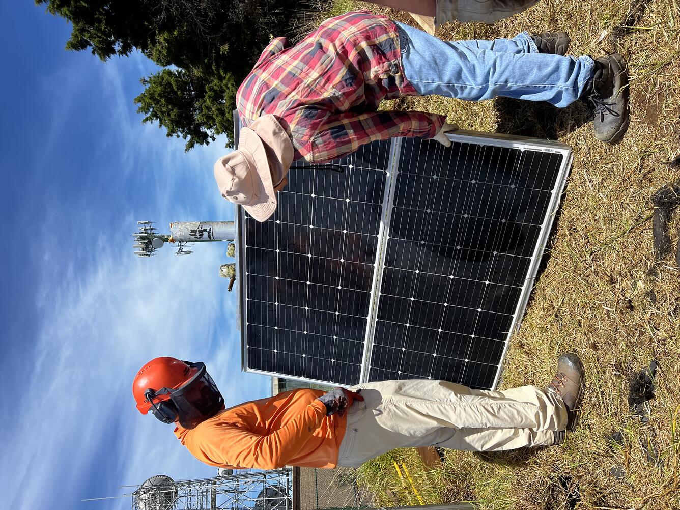 Color image of technicians installing solar panels