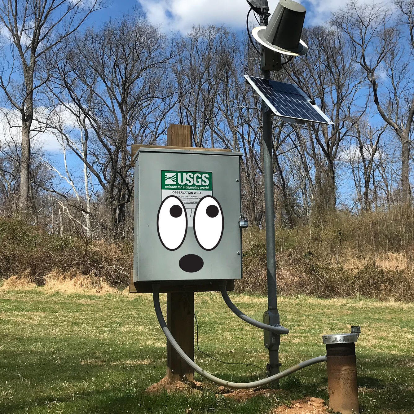 A streamgage with eyes drawn on.