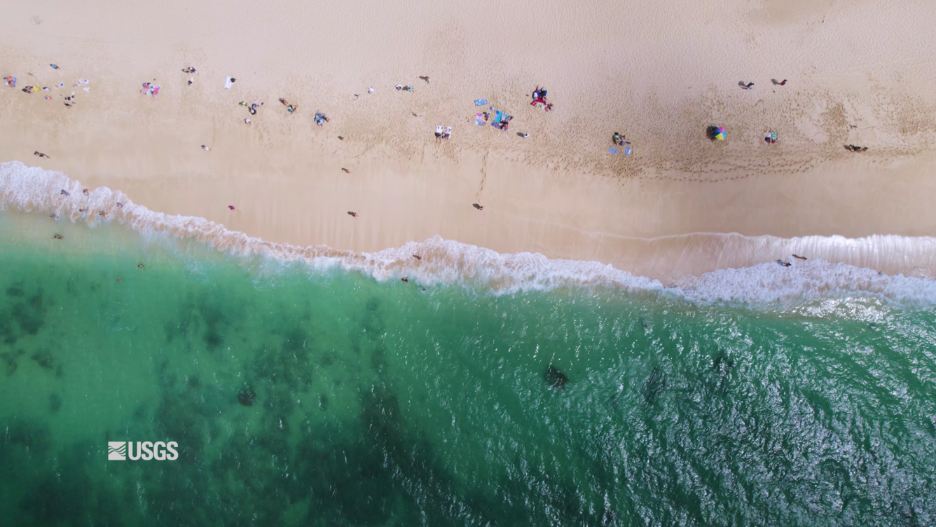 Aerial top-down footage of sandy shoreline on Oahu