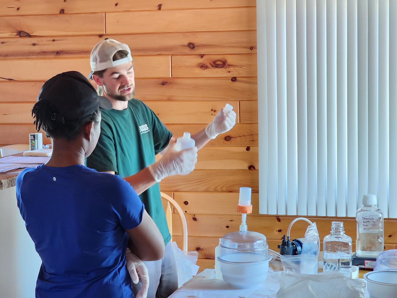 Scientist training another scientist on mercury sample processing